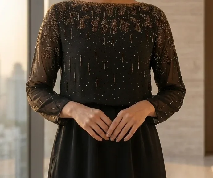 Detail crop from an existing garment photograph: Noir Beaded Mini / Construction detail