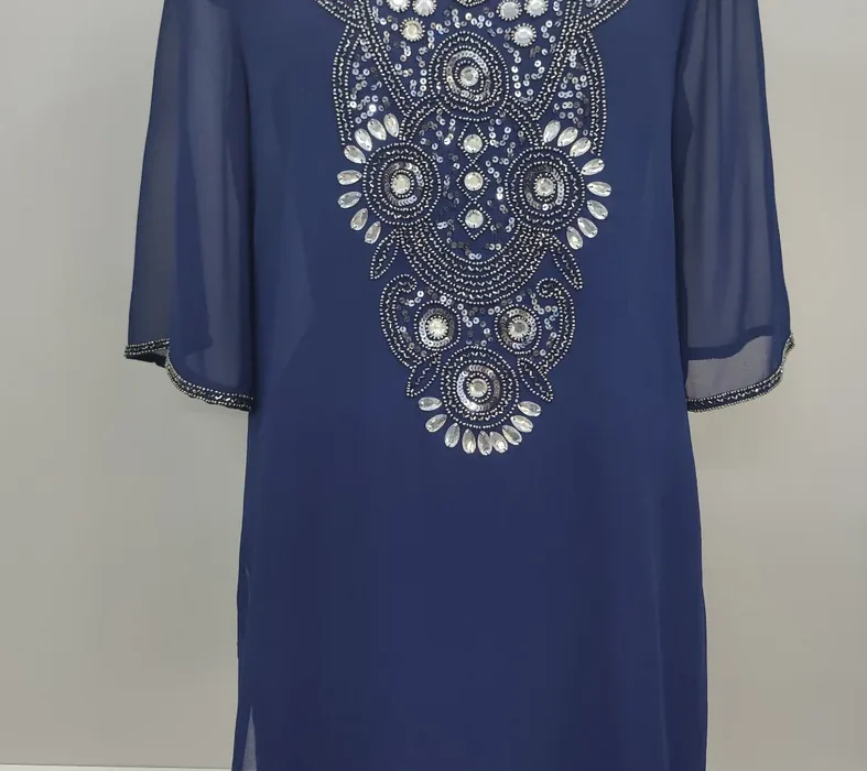 Detail crop from an existing garment photograph: Blue Embellished Tunic / Construction detail