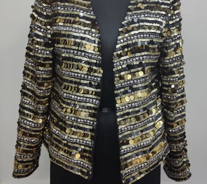 Detail crop from an existing garment photograph: Metallic Sequin Jacket / Embroidery detail